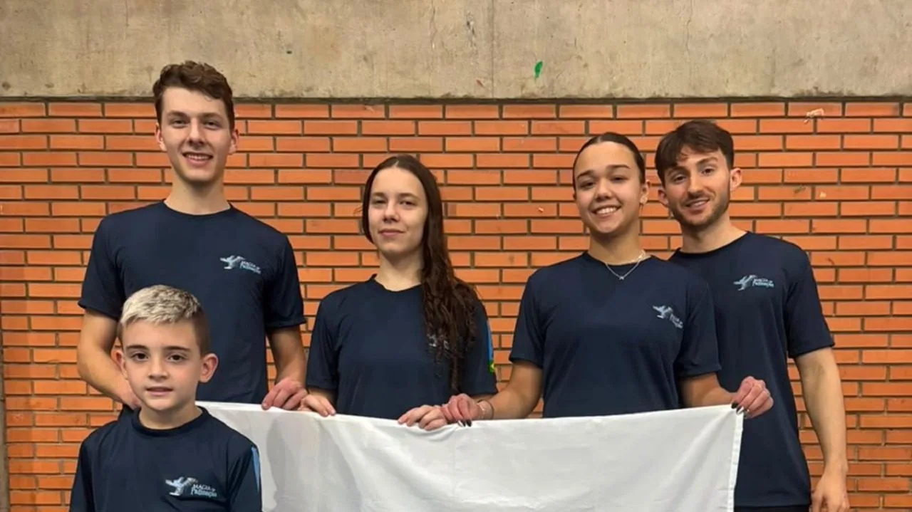 Quatro atletas e o técnico do Clube Magia da Patinação posam para uma foto antes da participação no Troféu Brasil de Patinação Artística 2026