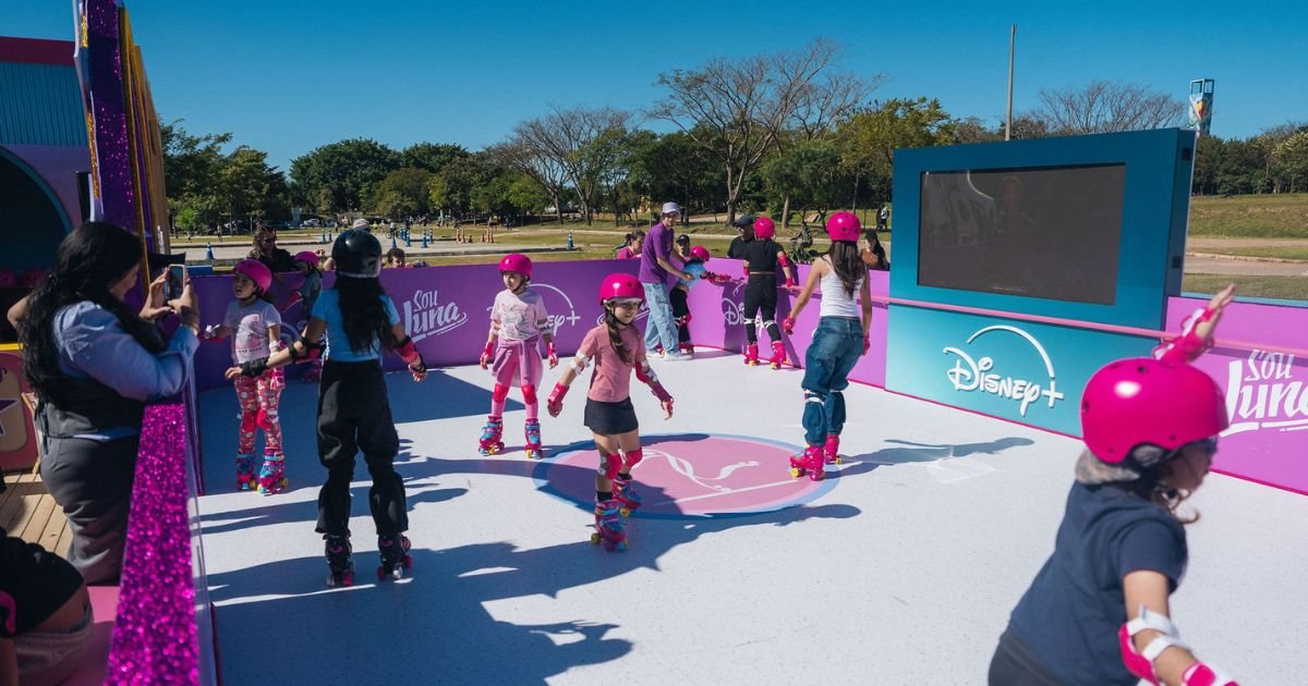 Crianças patinando em uma pista temática da Disney+ inspirada na série Sou Luna durante evento ao ar livre no Parque Villa-Lobos, em São Paulo.